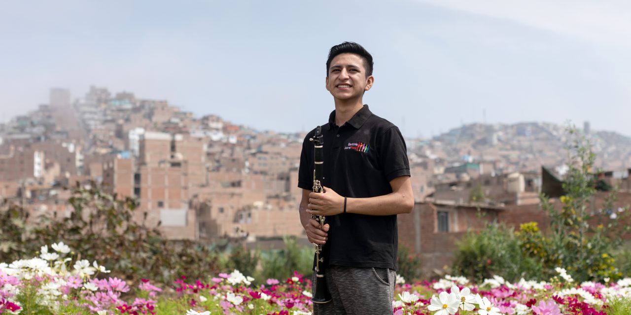 Athzel Pino (17) beneficiary of the Youth Orchestra "Sinfonia por el Peru" poses for a portrait with his clarinet in Lima, Peru
