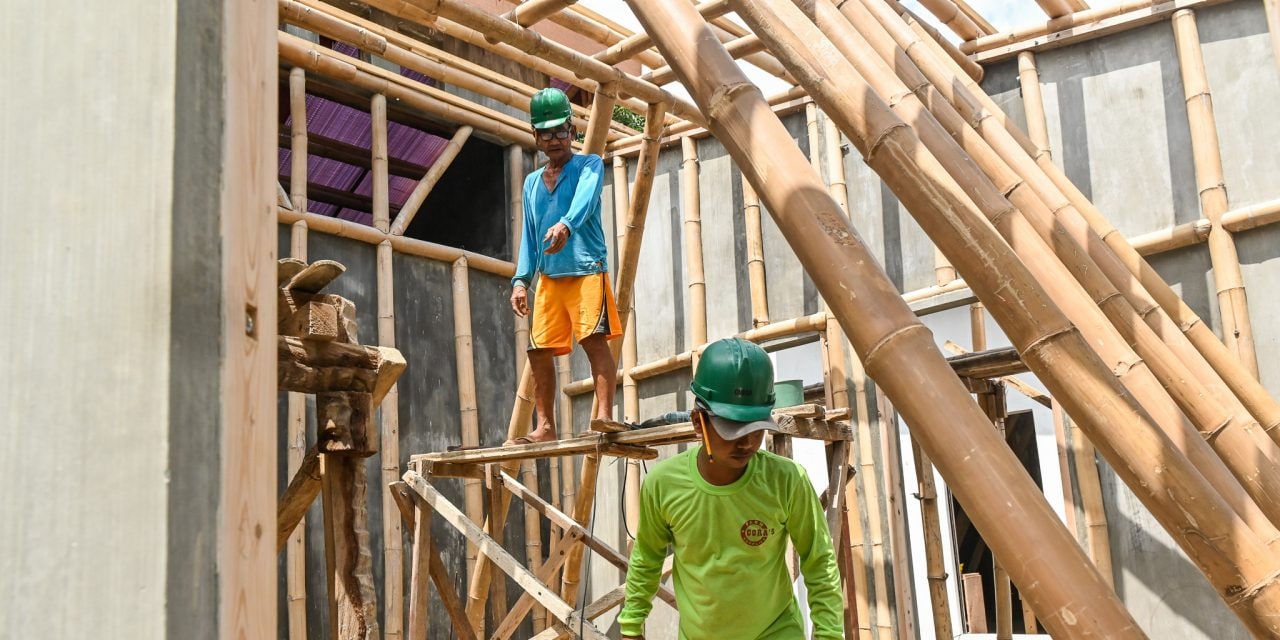 Workers build an orphanage using bamboo-cement technology in Batangas.